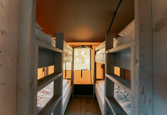 Udsigt over køjesenge i Ranger Lodge på Camping de Italiaanse Meren i Holland med varmt belysning.