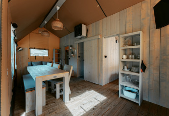 Interior of Ranger Lodge at Camping de Italiaanse Meren in the Netherlands featuring wood furnishings.