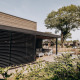 Udendørs udsigt over en moderne Luxury Lodge ved Soof Retreats i Holland med terrasse og havemøbler.