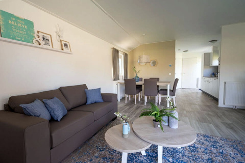Modern living and dining area at Lodge Velthorst 4 in Zuiderzee, Netherlands, with soft colors and stylish decor.
