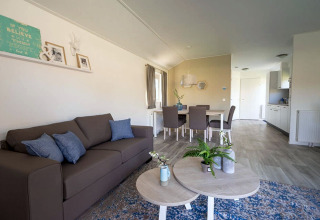 Modern living and dining area at Lodge Velthorst 4 in Zuiderzee, Netherlands, with soft colors and stylish decor.
