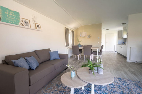 Soggiorno e sala da pranzo moderni nella lodge Velthorst 4 a Zuiderzee, Paesi Bassi, con arredi eleganti e colori chiari.