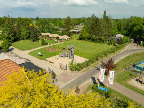 Aerial view of playground and green fields at Holiday Resort 't Schuttenbelt in Overijssel, Netherlands.