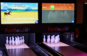 Indoor bowling lanes with digital scoreboard displays at FunBowl, a highlight of Vakantiepark de Zeeuwse Parel.