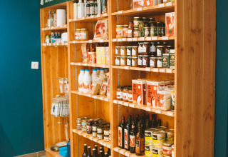 Houten rekken met streekproducten en wijn bij Huttopia Baie du Mont St Michel, Bretagne, Frankrijk.