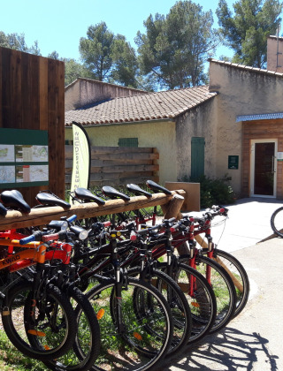 Bicicletas de alquiler junto al edificio de recepción en Huttopia Fontvieille, un parque vacacional en Provenza.