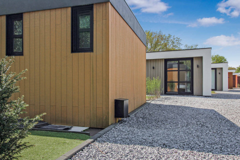 Casas de vacaciones modernas en el parque Uniq Leisure en Gelderland, Países Bajos, con fachada de madera.