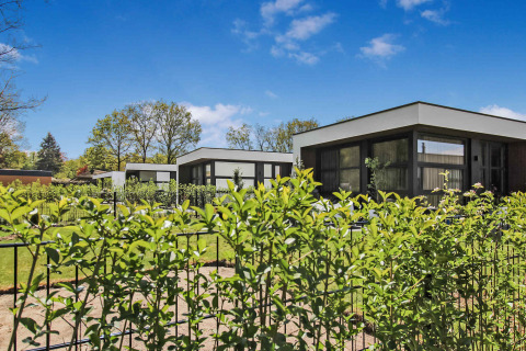 Modern holiday homes at Uniq Leisure holiday park in Gelderland, Netherlands, with lush green gardens