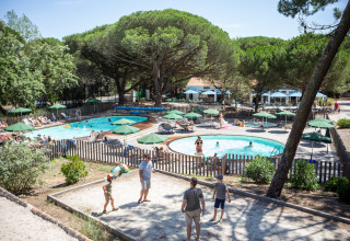 Holiday park pool and guests at Huttopia Chardons Bleus - Ile de Ré, Nouvelle-Aquitaine, France on a sunny day.