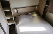 Moderne soveværelse på Chalet Portland, Huttopia Lac de Serre Ponçon, Frankrig med dobbeltseng og praktiske hylder.