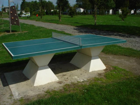 Tischtennisplatte im Freien auf einer Wiese im Camping Seasonova Saint Michel in der Normandie, Frankreich.