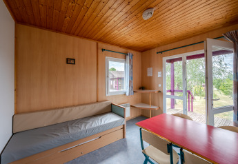 Interno dello Chalet ZEN al Camping Seasonova Les Vosges du Nord con pannelli in legno e porte aperte.