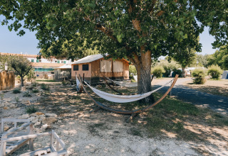 Camping Seasonova Ile de Ré: tenten, hangmatten en bomen in een zonnig vakantiepark in Nouvelle-Aquitaine, Frankrijk.