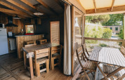 Interior and exterior view of the Lodge Premium cabin at Camping Seasonova Ile de Ré in France.