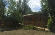 Casa móvil adaptada para discapacitados en Camping Seasonova Ile de Ré, Francia, entre árboles y valla.