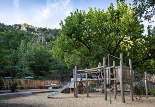 Natural playground at Huttopia Gorges du Tarn holiday park in Occitanie, France, surrounded by mountains.