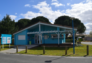 Lichtblauw onthaalgebouw bij Village Seasonova Bassin d'Arcachon, vakantiepark in Nouvelle-Aquitaine, Frankrijk.