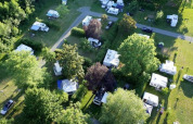 Aerial view of Camping Seasonova Les Plages de Loire showing caravans and lush greenery in France.