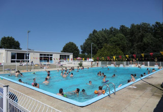 Outdoor swimming pool filled with people enjoying the sun at Camping Seasonova Les Plages de Loire, France.