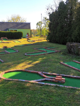 Mini golf course at Camping Seasonova Le Martinet in Centre-Val de Loire, France, in a lush green setting.