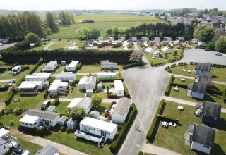 Aerial view of Camping Seasonova Etennemare holiday park in Normandy, France, with cabins and greenery.