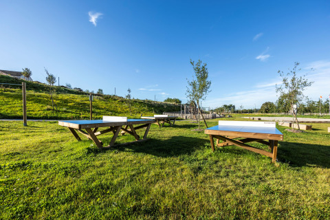 Mesas de ping-pong al aire libre en el césped del parque vacacional Domaine Seasonova Saâne et Mer en Normandía.