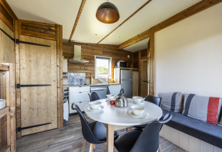 Cocina y comedor modernos en una cabaña Prestige Cottage en Domaine Seasonova Saâne et Mer, Francia.
