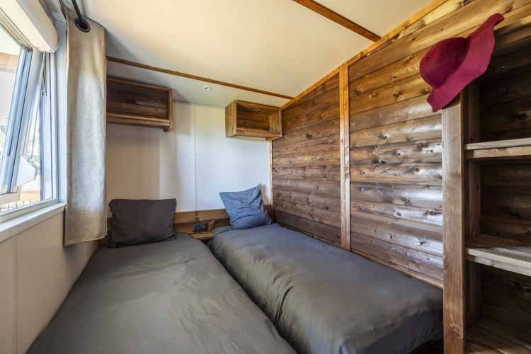 Two single beds with gray linens in a Prestige Cottage room at Domaine Seasonova Saâne et Mer, France.