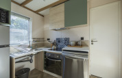 Accessible kitchen in Cottage PMR lodge with modern appliances at Domaine Seasonova Saâne et Mer in France.