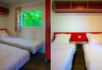 Two single beds in a bright, modern Mobilodge safari tent at Camping Seasonova La Forêt, France.