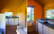 Interior of safari tent at Slow Lodge, Camping Seasonova La Forêt, France, with kitchen and wooden floor.