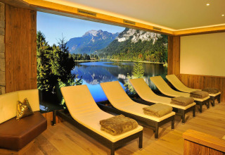 Relaxation room with loungers and blankets, offering a stunning lake and mountain view at Seeblick Toni, Tirol.