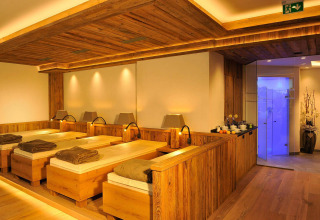 Relaxation room with wooden loungers and warm lighting at Camping Seeblick Toni, Tirol, Austria.