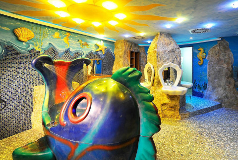 Kleurrijke badkamer met onderwaterthema, schelpenwastafels en visbad bij Camping Seeblick Toni in Tirol.