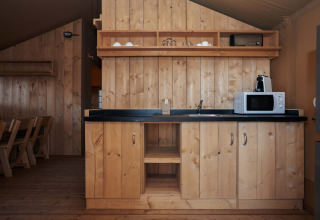 Angolo cucina nella tenda safari Glamping Tramuntana al Camping Mas Patoxas in Spagna, tutto in legno.