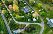 Luftfoto af Camping Seasonova Le Martinet i Centre-Val de Loire, Frankrig med campingvogne og grønne områder.