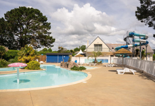 Udendørs swimmingpoolområde med vandrutsjebaner og liggestole på Camping Kost Ar Moor i Bretagne, Frankrig.