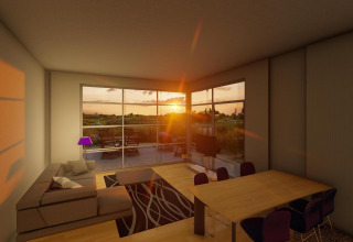 Woonkamer in Cube Exclusif lodge tijdens zonsondergang bij EuroParcs De Zeeuwse Duinen, met terraszicht.