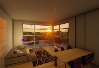 Salón del lodge Cube Exclusif al atardecer en EuroParcs De Zeeuwse Duinen, con vista a la terraza.