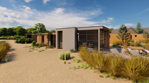 Cube Exclusif lodge en EuroParcs De Zeeuwse Duinen, Países Bajos, casa moderna rodeada de paisaje arenoso.