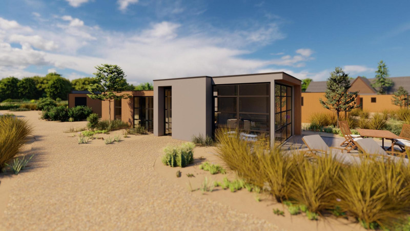 Cube Exclusif lodge at EuroParcs De Zeeuwse Duinen in the Netherlands, modern design set in sandy terrain.