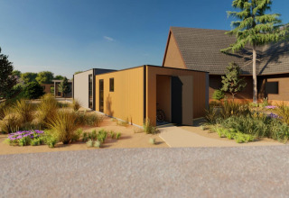 Lodge Cube Exclusif moderno a EuroParcs De Zeeuwse Duinen, Olanda, circondato dalla natura verde.