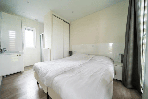 Camera luminosa presso il Pavilion di EuroParcs Veluwemeer, Paesi Bassi, con letto matrimoniale e armadio.