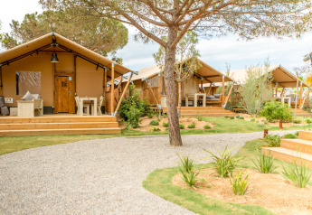 Safari tents at Glamping Mar, Camping del Mar in Spain, featuring wooden decks and lush garden landscaping.