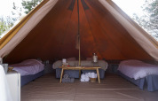 Vista interior de la tienda tipi Bell Escape Family en Little Canvas Escape, Países Bajos, con tres camas.