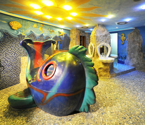 Colorful undersea-themed bathroom with fish-shaped shower at Camping Seeblick Toni holiday park in Tirol, Austria.