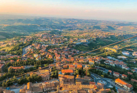 Aerial photo of the area around Cailungo, San Marino, Italy, showing the town, hills, and scenic landscape.