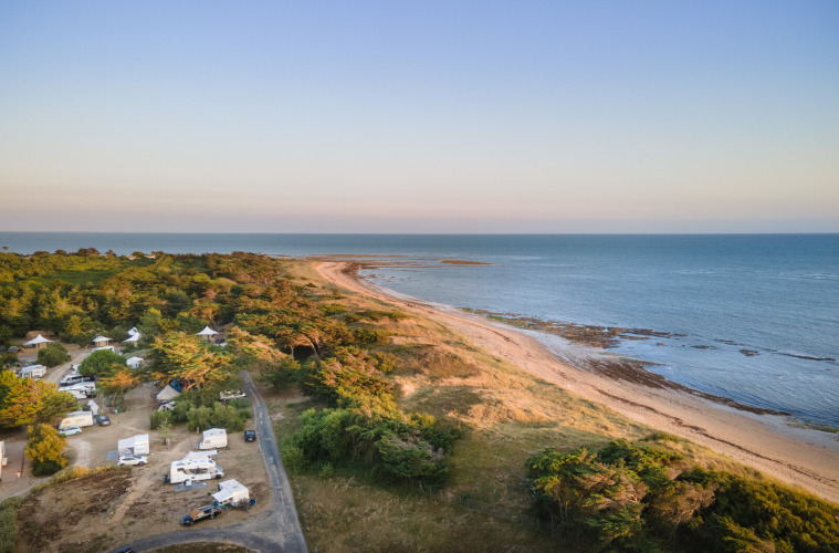 Coastal campsite near Ars-en-Ré in Nouvelle-Aquitaine, France, featuring ocean views and scenic greenery.