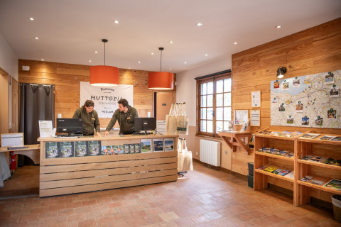 Reception area at Huttopia Calvados - Normandie holiday park in France, staff behind the counter.
