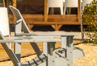 Zwei graue Holzliegen vor dem Base Lodge Safarizelt bei Boutique Camping Heart of Nature in Kroatien.